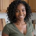 Aisha, 31, EvaDate reviewer cooking in her kitchen